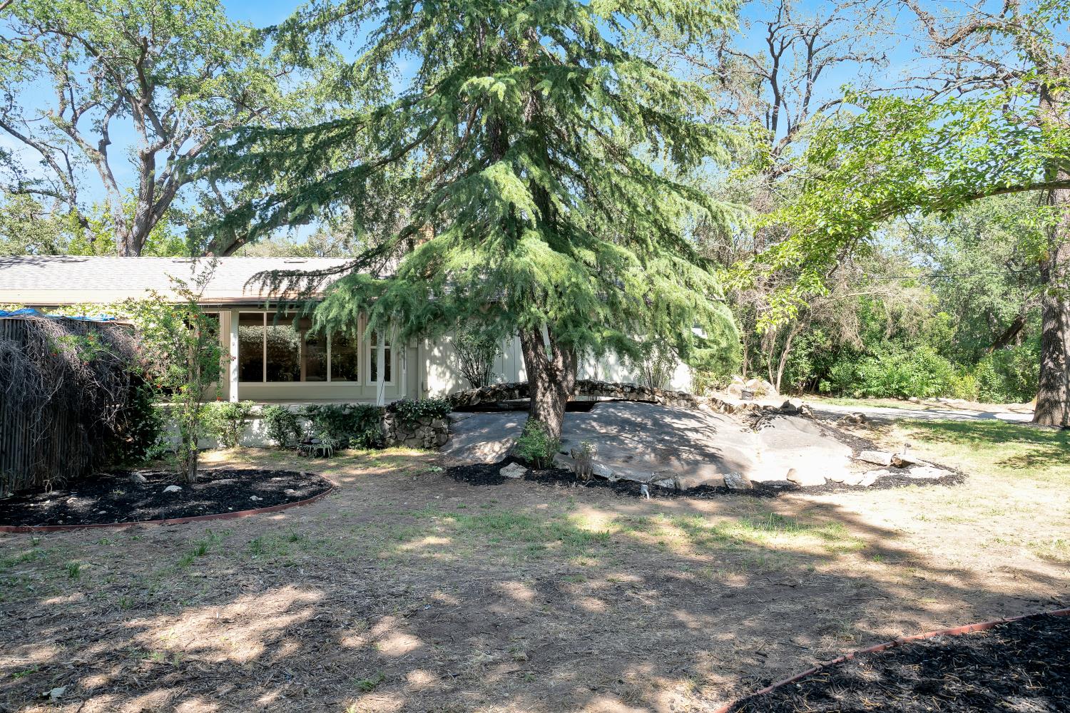 6299 Horseshoe Bar Road Loomis, CA 95650 - Photo 33 of 43 a view of a house with a yard