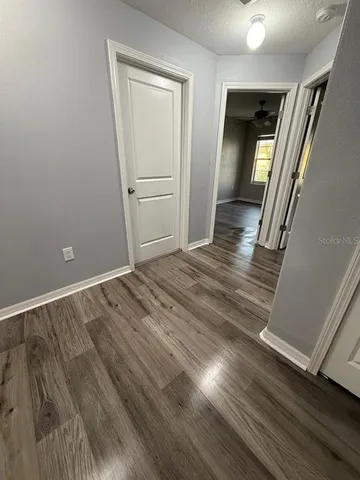 wooden floor in an empty room with a mirror