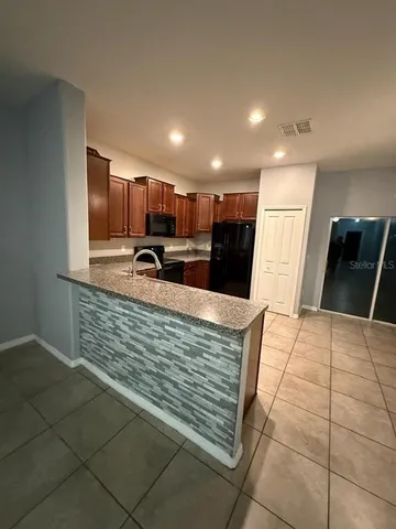 a kitchen with stainless steel appliances granite countertop a sink and a stove