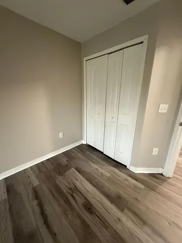 a view of an empty room and wooden floor