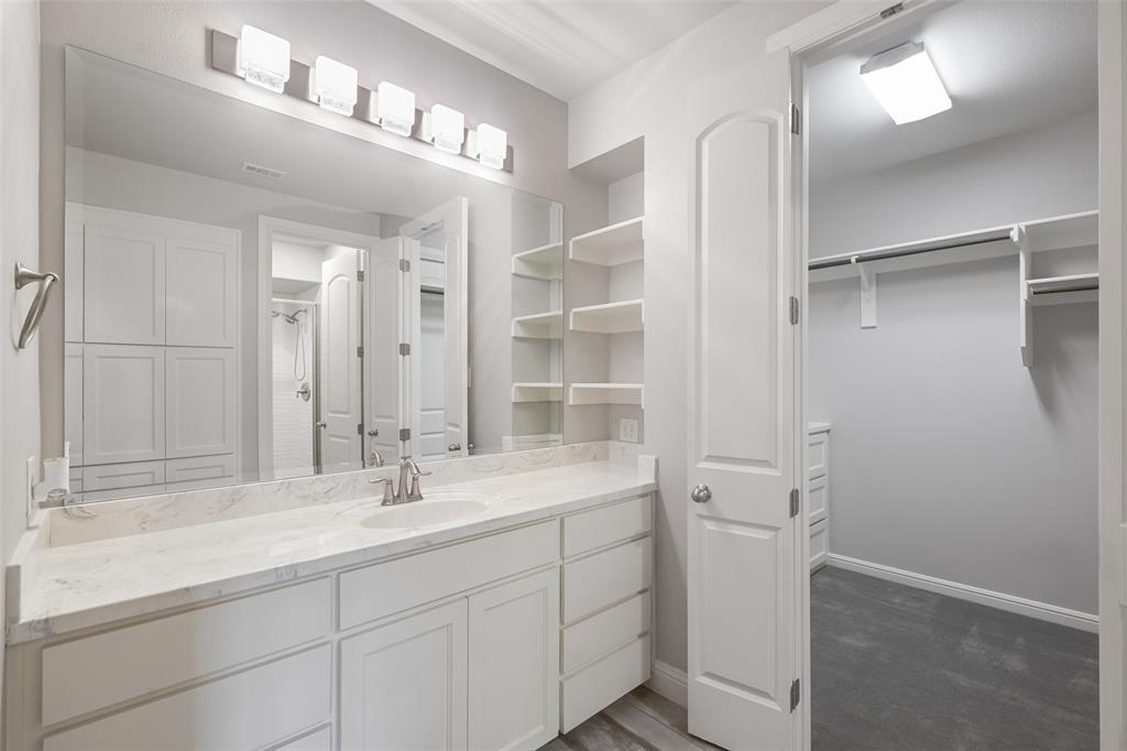 1657 Florence Road Keller, TX 76262 - Photo 26 of 40 a bathroom with a double vanity sink and mirror