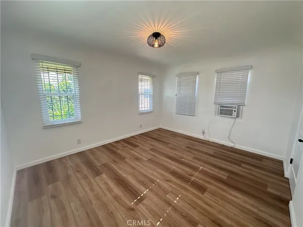 a view of a livingroom with wooden floor and staircase
