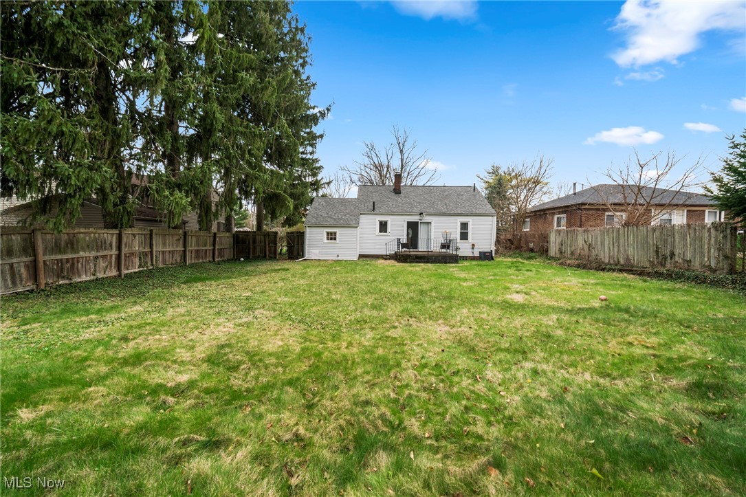 187 Everhard Road Southwest North Canton, OH 44720 - Photo 15 of 19 Back of house with a fenced backyard, a deck, and a chimney