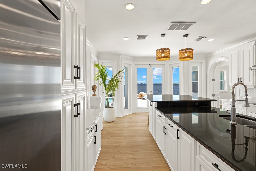 8451 Casa Del Rio Lane Fort Myers, FL 33919 - Photo 15 of 50 a large kitchen with a large window and stainless steel appliances