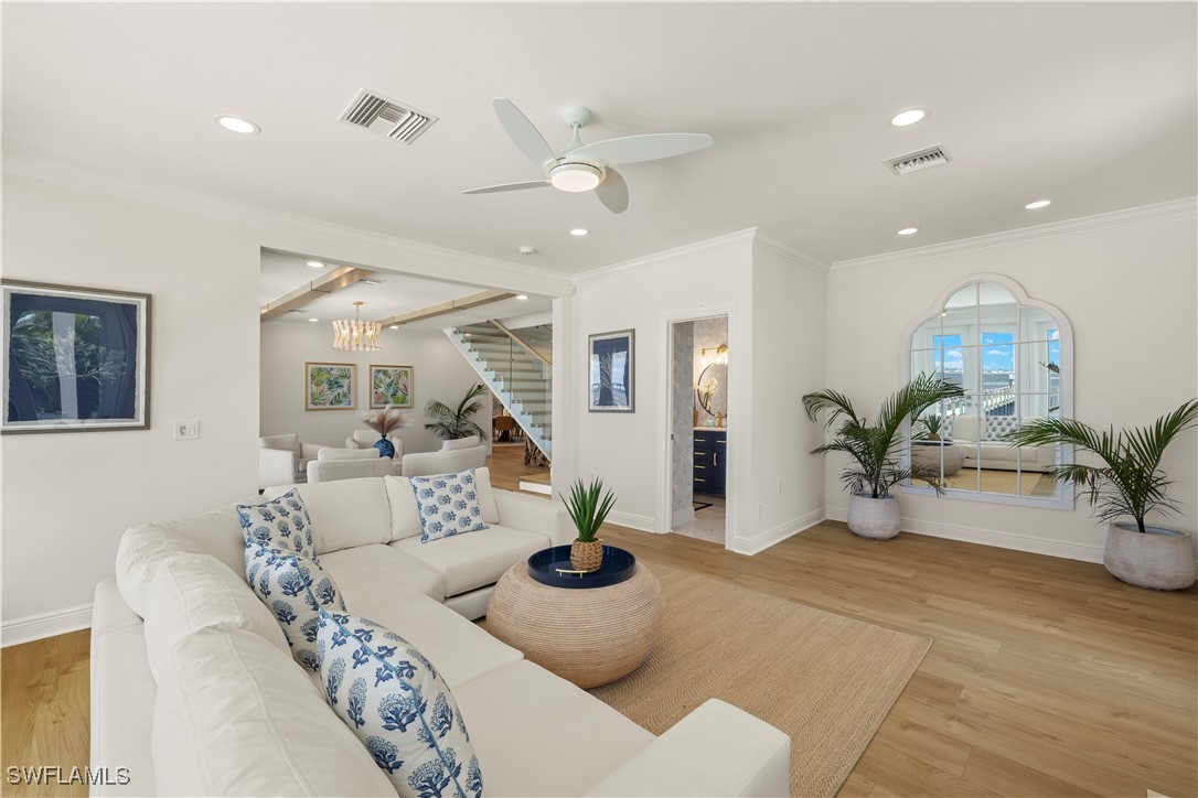 8451 Casa Del Rio Lane Fort Myers, FL 33919 - Photo 19 of 50 a living room with furniture potted plant and a chandelier