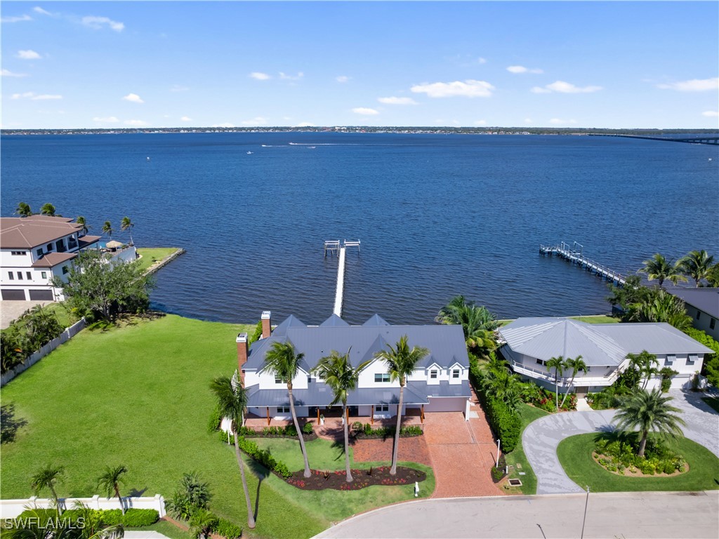 8451 Casa Del Rio Lane Fort Myers, FL 33919 - Photo 2 of 50 an aerial view of a house with garden space and outdoor seating