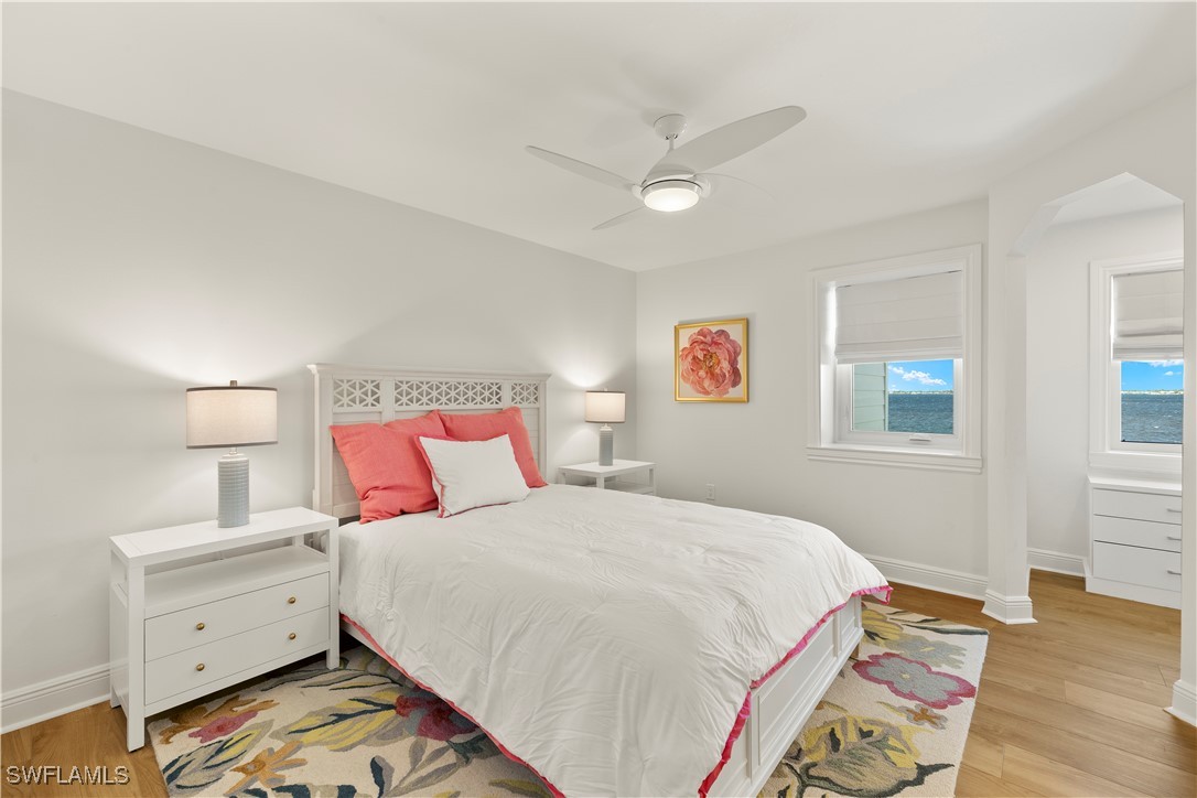 8451 Casa Del Rio Lane Fort Myers, FL 33919 - Photo 32 of 50 a bedroom with a bed and wooden floor