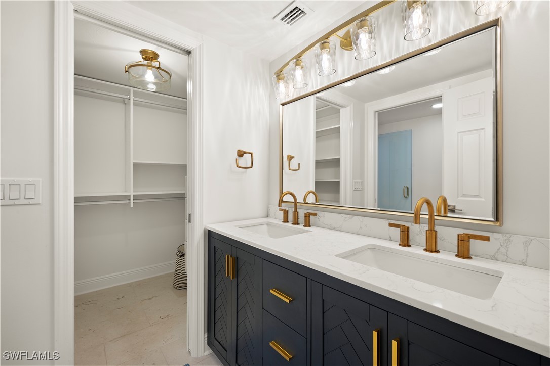 8451 Casa Del Rio Lane Fort Myers, FL 33919 - Photo 37 of 50 a bathroom with a sink double vanity and a mirror