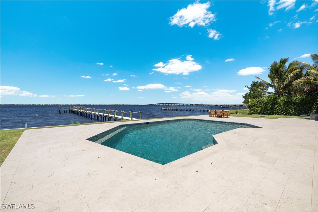 8451 Casa Del Rio Lane Fort Myers, FL 33919 - Photo 4 of 50 a view of a swimming pool and an outdoor space