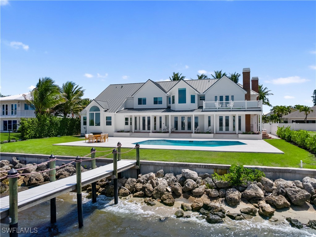 8451 Casa Del Rio Lane Fort Myers, FL 33919 - Photo 46 of 50 a view of a swimming pool and a yard