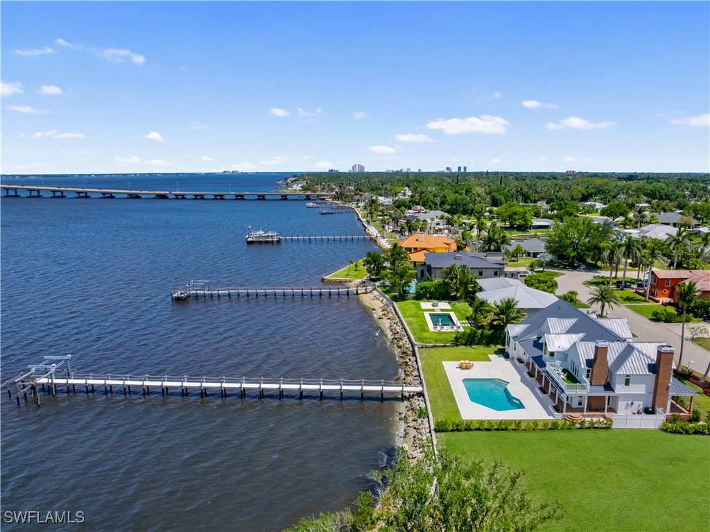 8451 Casa Del Rio Lane Fort Myers, FL 33919 - Photo 48 of 50 an aerial view of a house with a garden and lake view