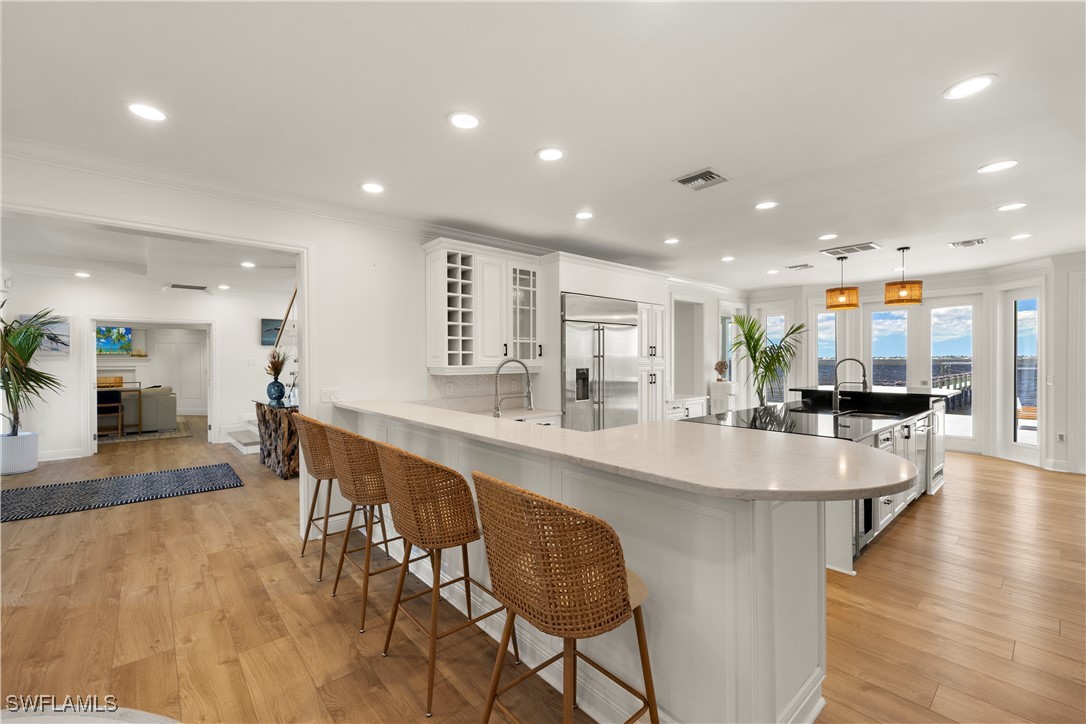 8451 Casa Del Rio Lane Fort Myers, FL 33919 - Photo 10 of 50 a large kitchen with stainless steel appliances lots of counter space and breakfast area