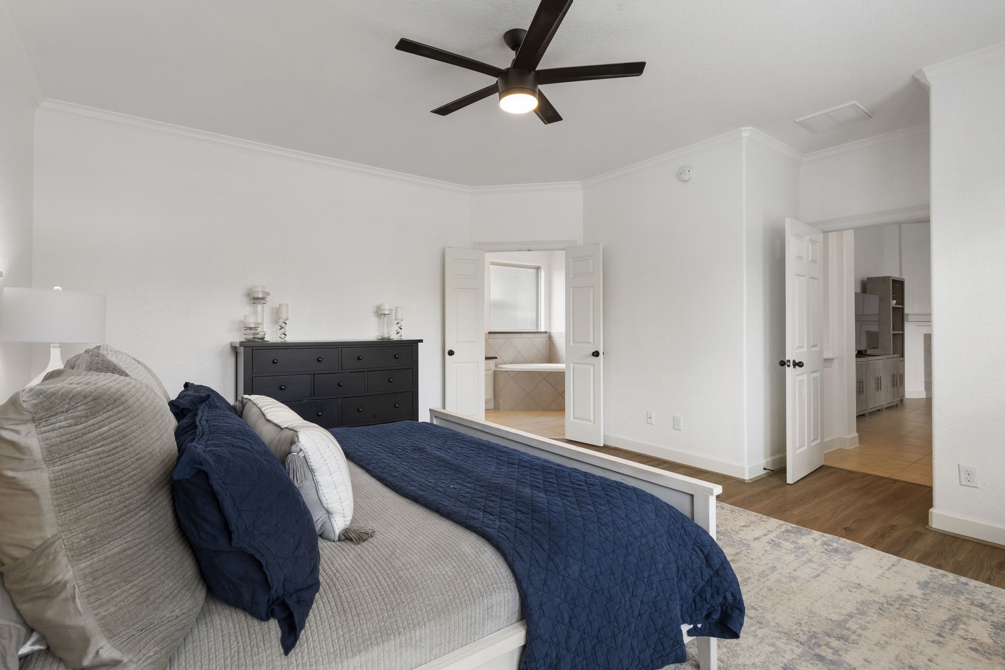 71 Sagamore Ridge Place The Woodlands, TX 77389 - Photo 21 of 34 a bedroom with a bed and a view of kitchen