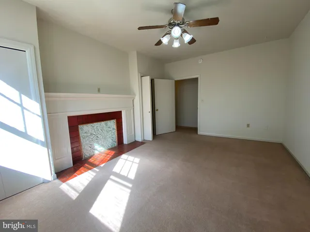 a view of empty room with fireplace