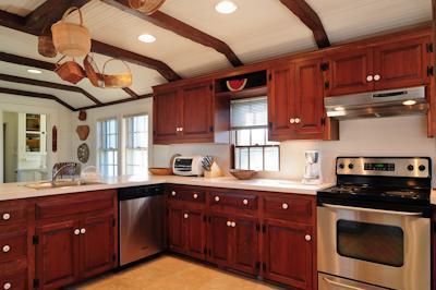 108 Shore Road Chatham, MA 02633 - Photo 17 of 31 a kitchen with stainless steel appliances granite countertop a sink a stove and cabinets