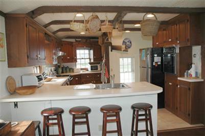 108 Shore Road Chatham, MA 02633 - Photo 18 of 31 a kitchen with granite countertop a sink and refrigerator