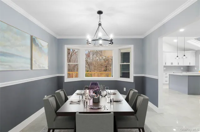 a view of a dining room with furniture wooden floor and chandelier
