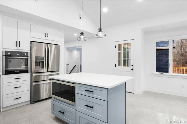 a kitchen with a sink stainless steel appliances and cabinets