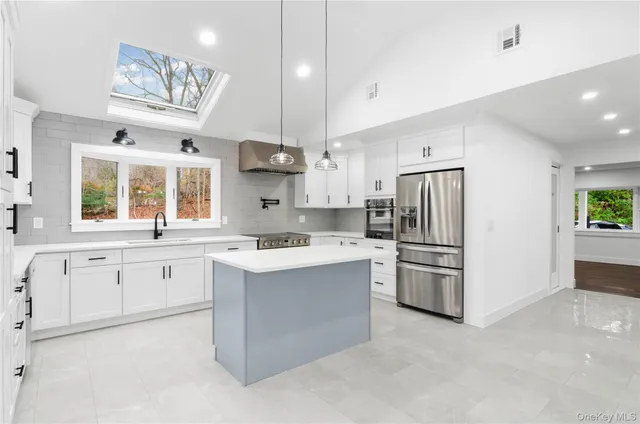 a large kitchen with cabinets and stainless steel appliances