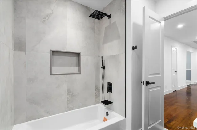 a bathroom with a bathtub and shower