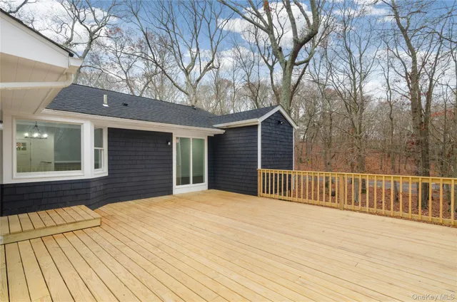 a view of backyard with a deck and wooden floor