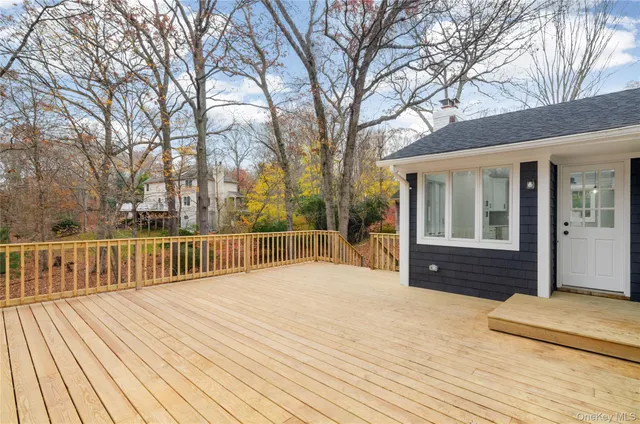 a view of backyard with deck and wooden floor