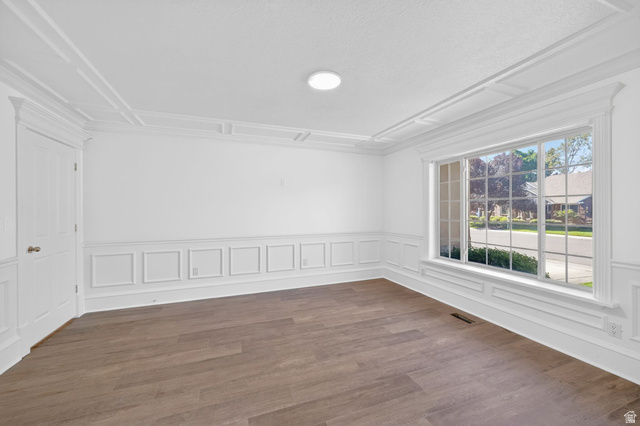 883 East 700 South Springville, UT 84663 - Photo 11 of 59 Spacious room featuring wood-finish flooring, white paneled wainscoting, and elaborate crown molding