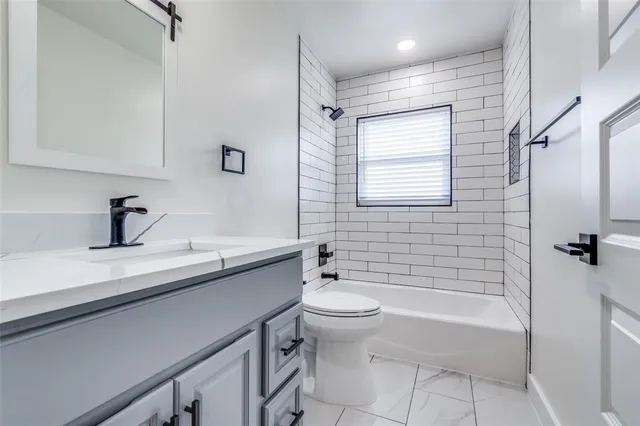 a bathroom with a double vanity sink toilet and shower