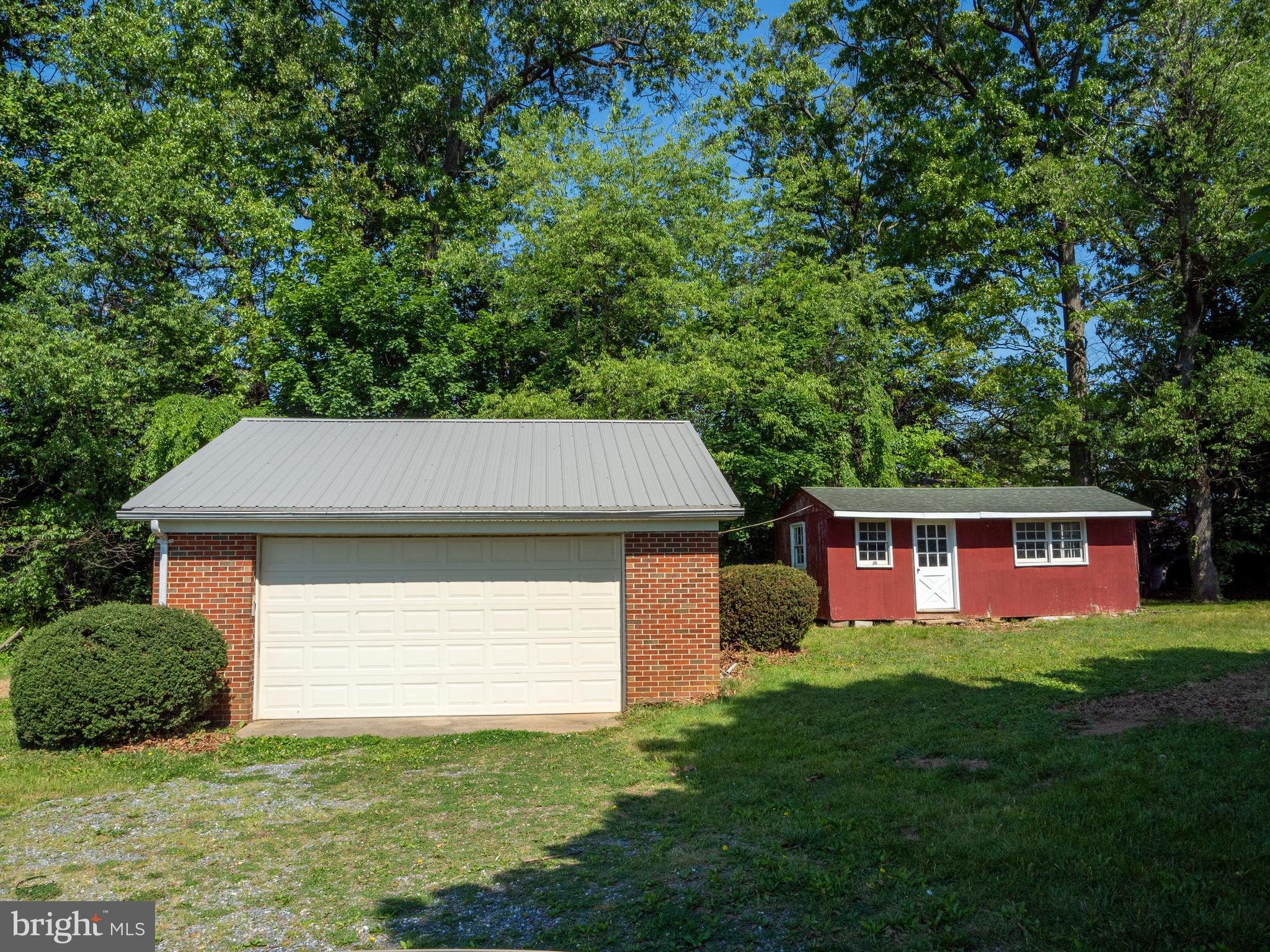 26906 Clarksburg Road Damascus, MD 20872 - Photo 3 of 17 a front view of a house with a yard and garage
