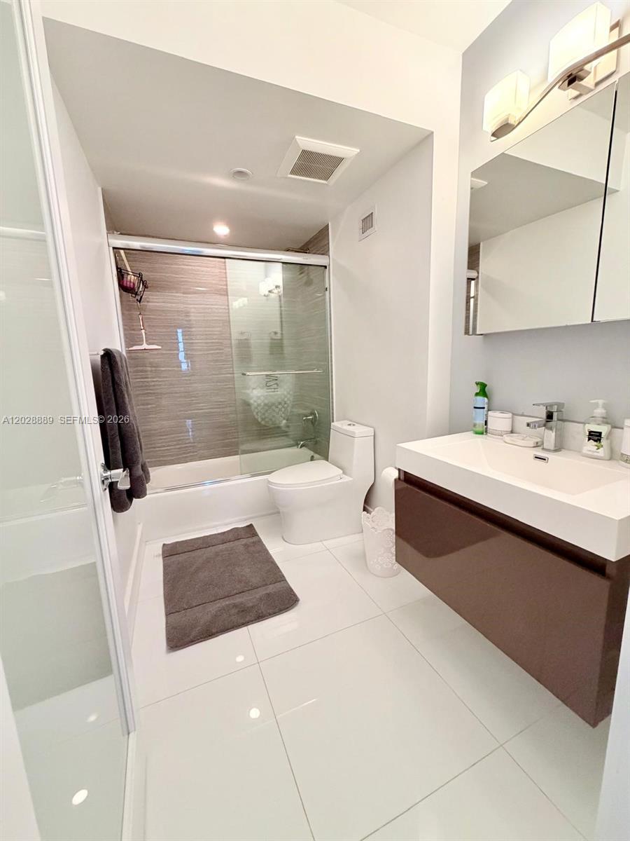 100 Lincoln Road, Unit 1504 Miami Beach, FL 33139 - Photo 6 of 17 a bathroom with a sink a mirror and a shower