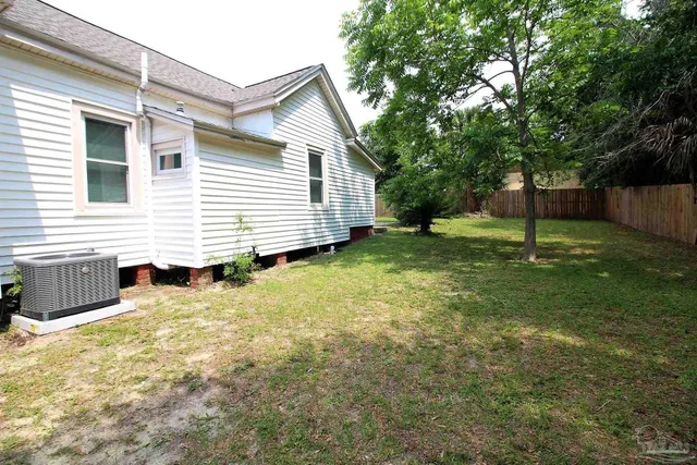 a view of backyard of house with green space