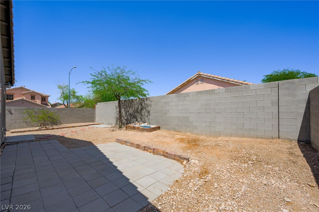 6762 Arapaho Ranch Las Vegas, NV 89148 - Photo 26 of 27 A spacious backyard with block fencing and mature landscaping offers an ideal canvas for outdoor living.
