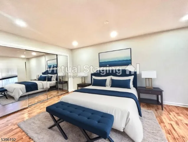 a spacious bedroom with a bed a couch and dresser