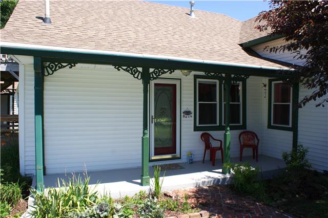 In addition to a large lot with beautiful trees and a white picket fence, this home has three porches, and an upstairs deck. 