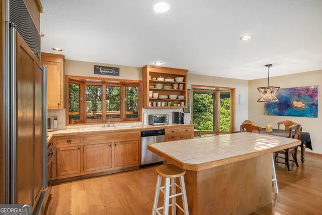a kitchen with a stove a sink and a refrigerator