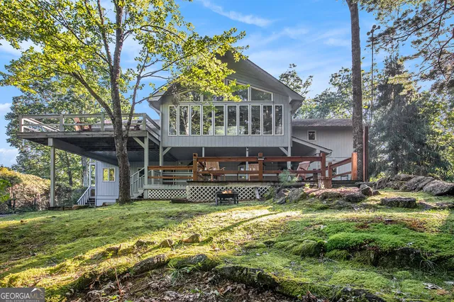 a view of a house with a yard balcony and sitting area