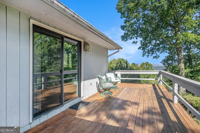 a view of deck with chairs and wooden floor