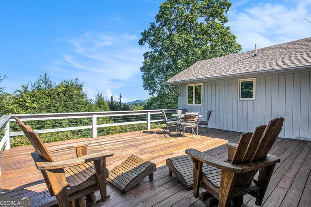 a view of a chairs and table on the deck