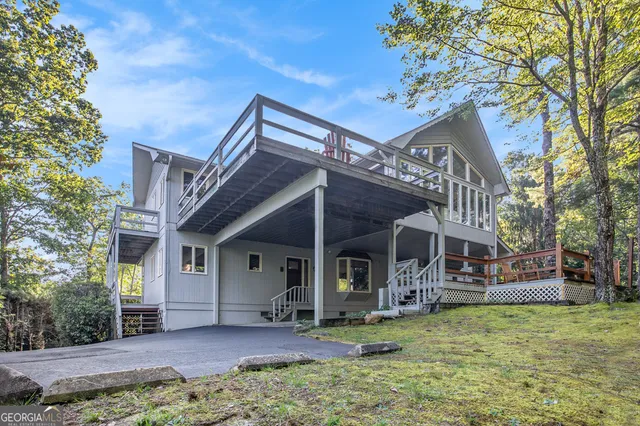 a view of a house with backyard porch and sitting area
