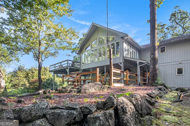 a front view of house with yard and trees around