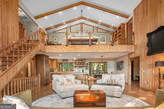 a large living room with a fireplace a couch and a ceiling fan