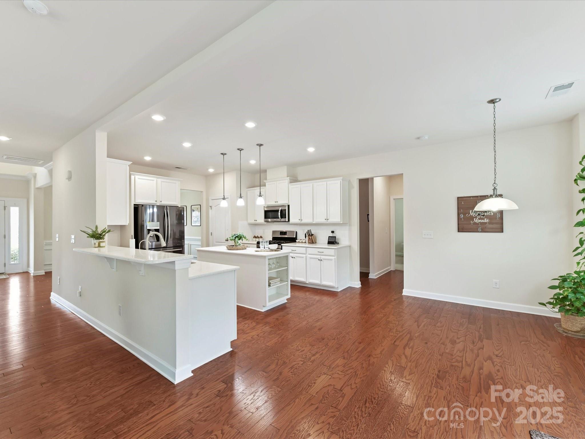 9895 Travertine Trail Davidson, NC 28036 - Photo 12 of 48 a view of kitchen with stainless steel appliances refrigerator stove microwave and cabinets