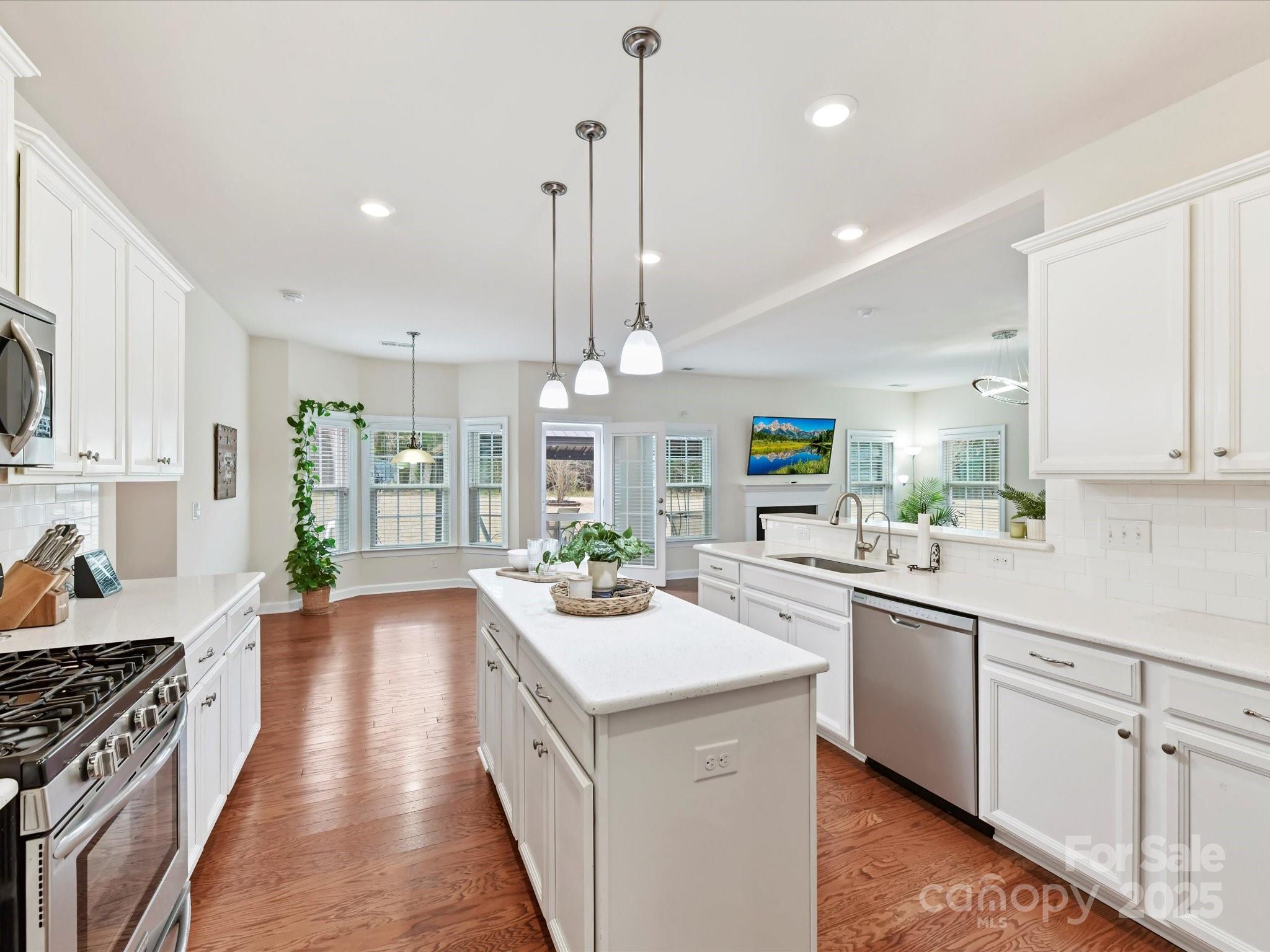 9895 Travertine Trail Davidson, NC 28036 - Photo 15 of 48 a kitchen with a sink stove and wooden cabinets