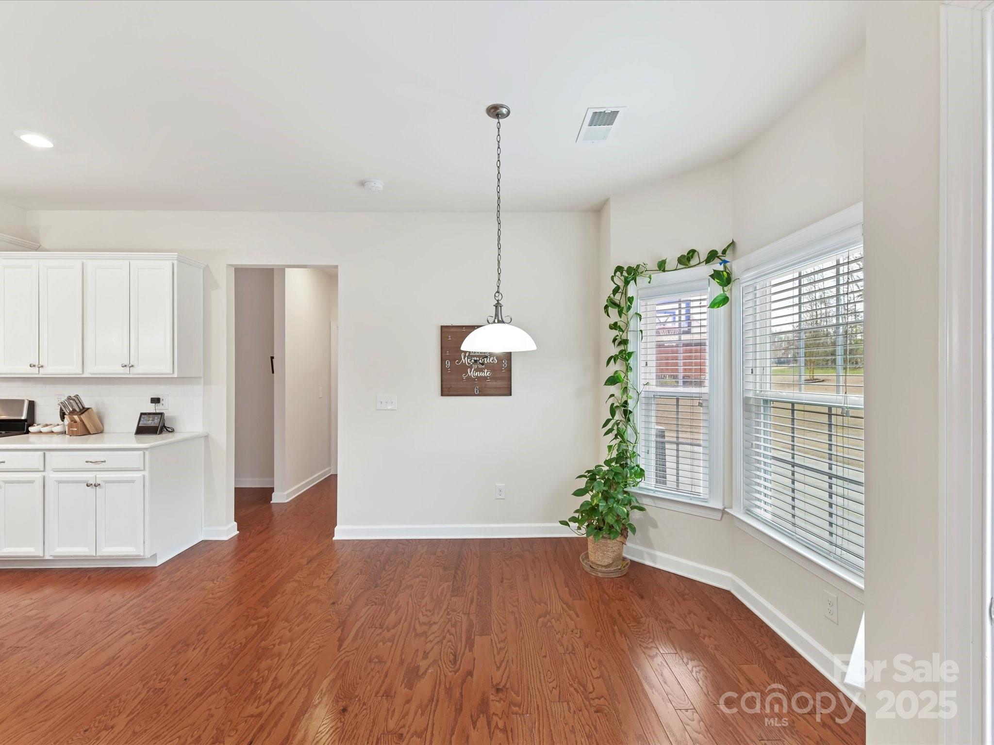 9895 Travertine Trail Davidson, NC 28036 - Photo 16 of 48 a view of a kitchen with wooden floor and white appliances