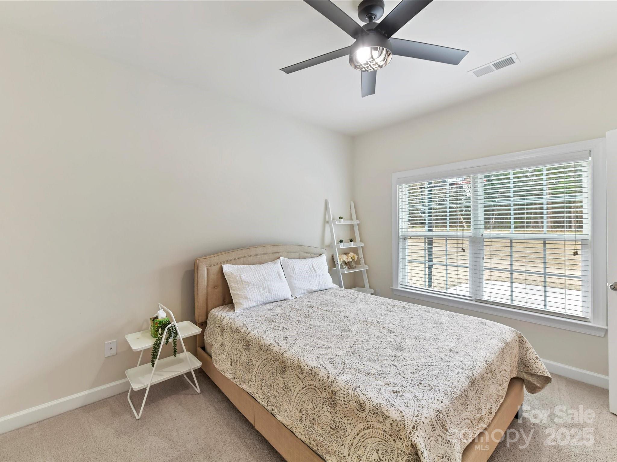 9895 Travertine Trail Davidson, NC 28036 - Photo 18 of 48 a bedroom with a bed and window
