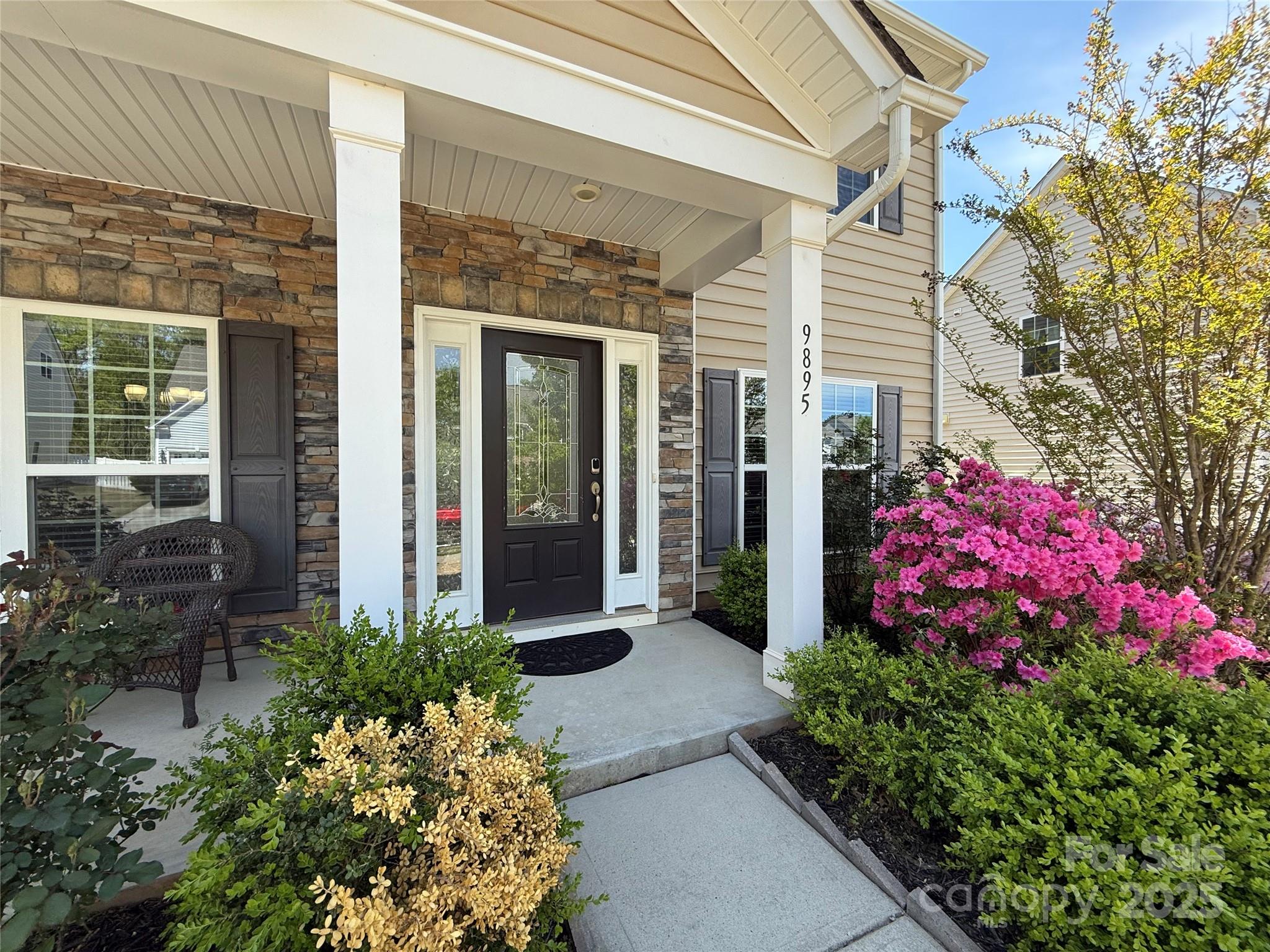 9895 Travertine Trail Davidson, NC 28036 - Photo 2 of 48 front view of a house with a flower garden