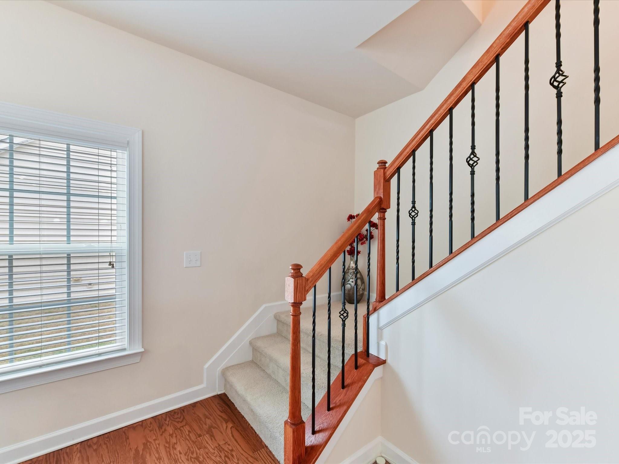 9895 Travertine Trail Davidson, NC 28036 - Photo 23 of 48 a view of staircase with wooden floor and a window