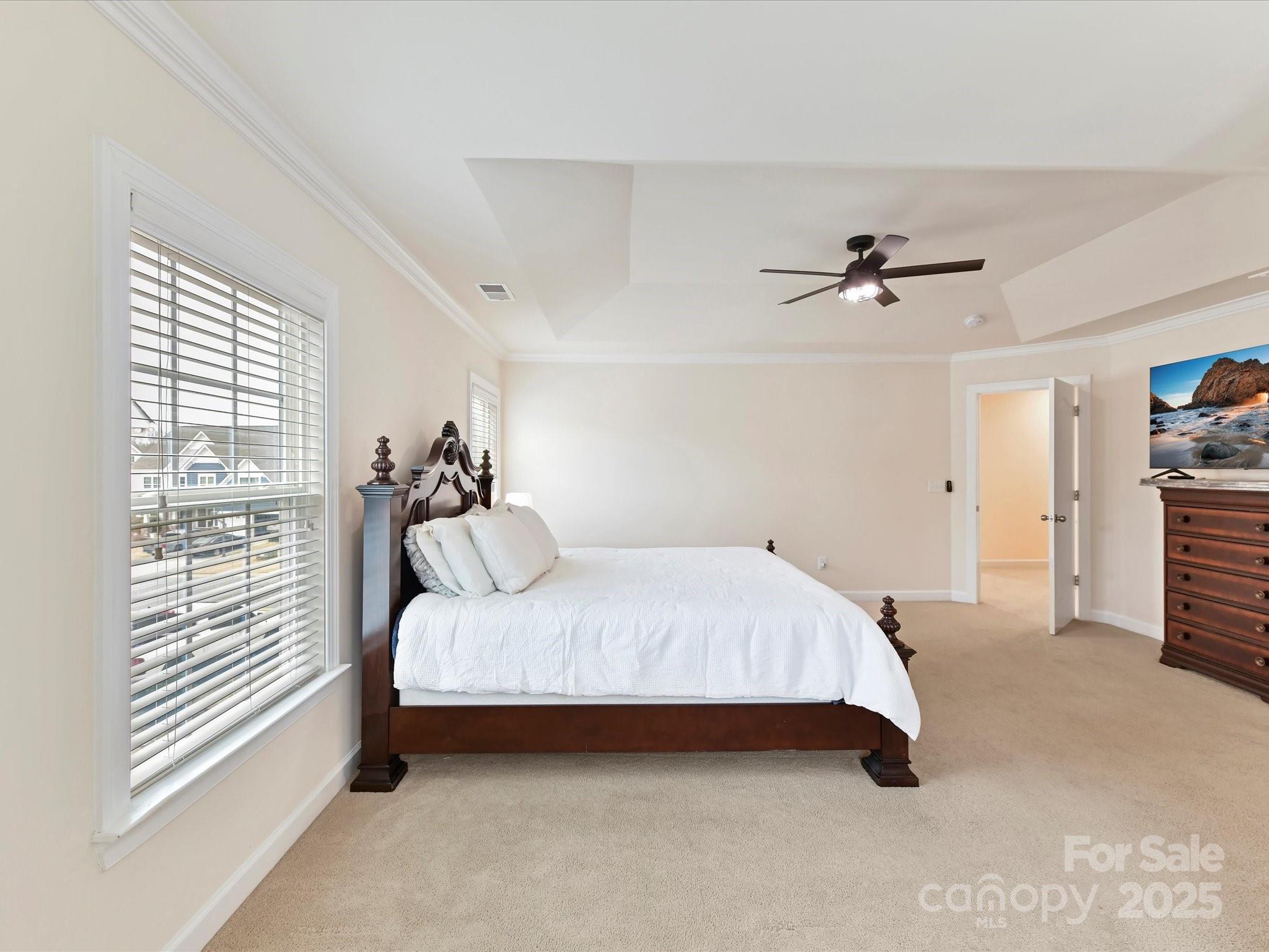 9895 Travertine Trail Davidson, NC 28036 - Photo 28 of 48 a spacious bedroom with a bed and a chandelier