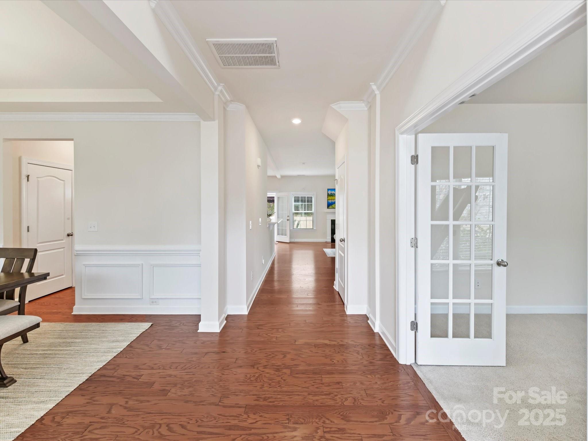9895 Travertine Trail Davidson, NC 28036 - Photo 3 of 48 a view of a hallway with wooden floor and a living room