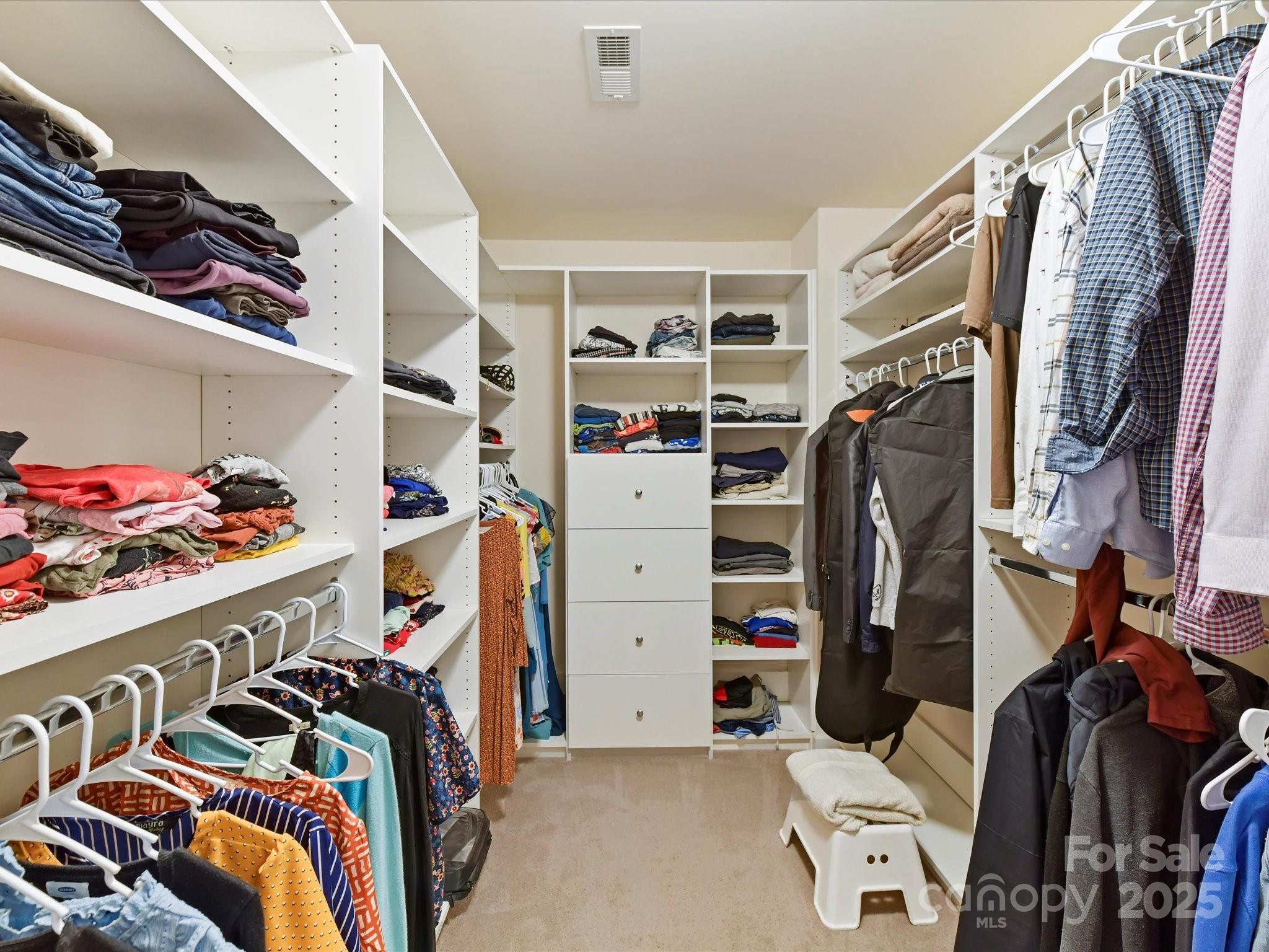 9895 Travertine Trail Davidson, NC 28036 - Photo 31 of 48 a view of walk in closet with clothes and shoes